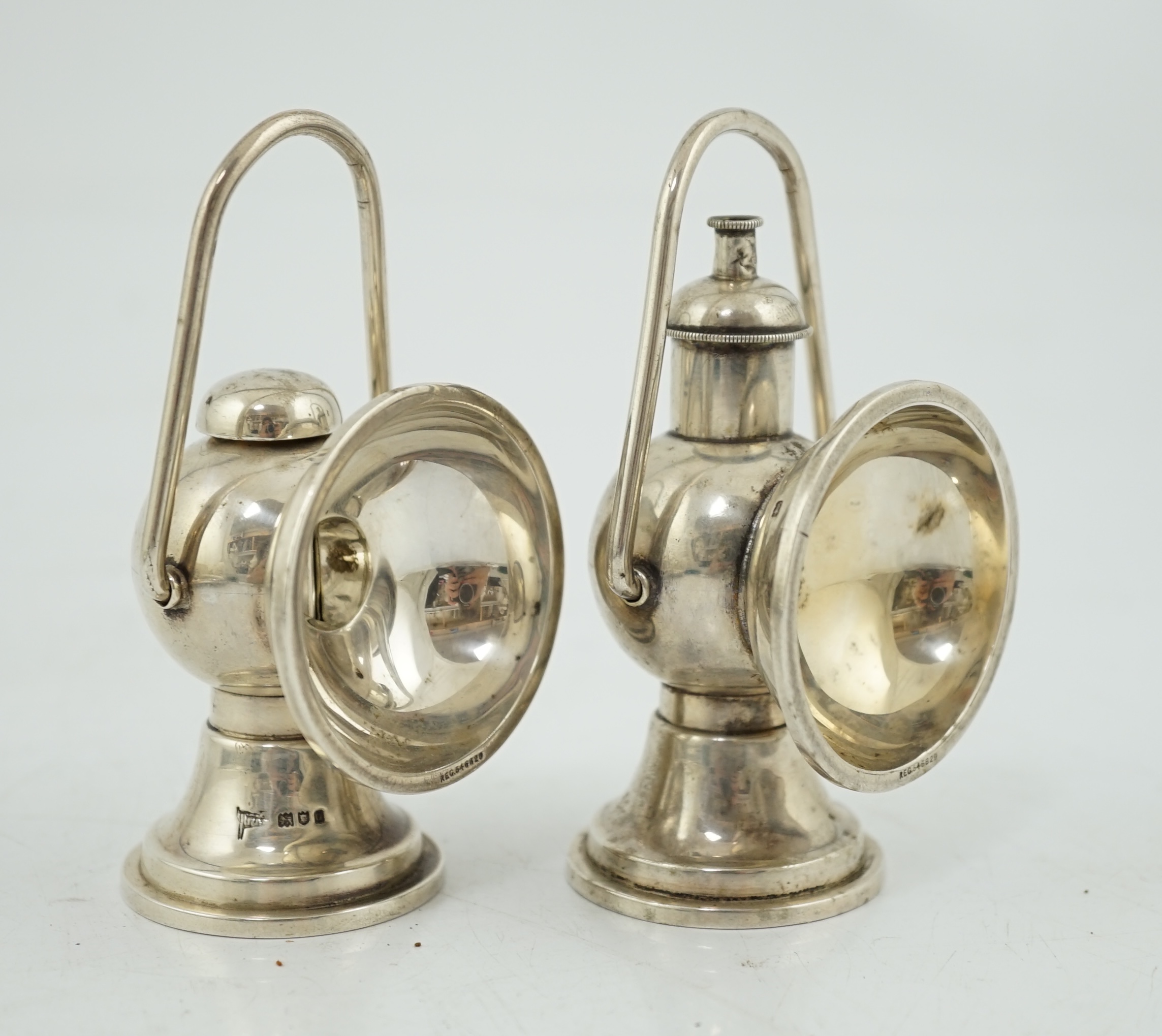 An Edwardian novelty cigar cutter and perpetual lighter, modelled as a pair of railway lamps, by Walker & Hall